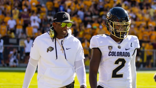 Oct 7, 2023; Tempe, Arizona, USA; Colorado Buffaloes head coach Deion Sanders with son and quarterback Shedeur Sanders (2) against the Arizona State Sun Devils at Mountain America Stadium. Mandatory Credit: Mark J. Rebilas-USA TODAY Sports 